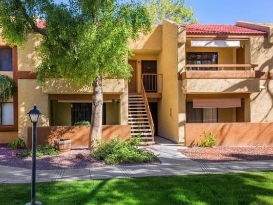 Exterior of Sun Wood Senior facility showing stairs and landscaping.