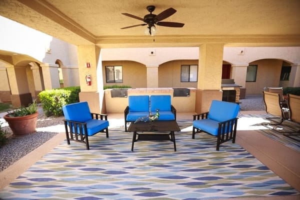 Comfortable blue chairs and a table on a patio