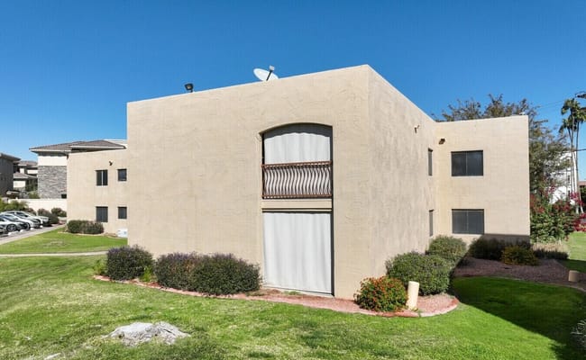 Exterior of a beige building at Hacienda De Los Arcos