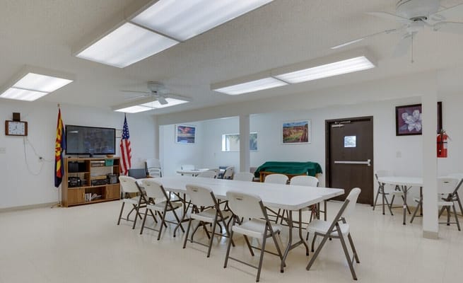 Bright common area with tables, chairs, and decor