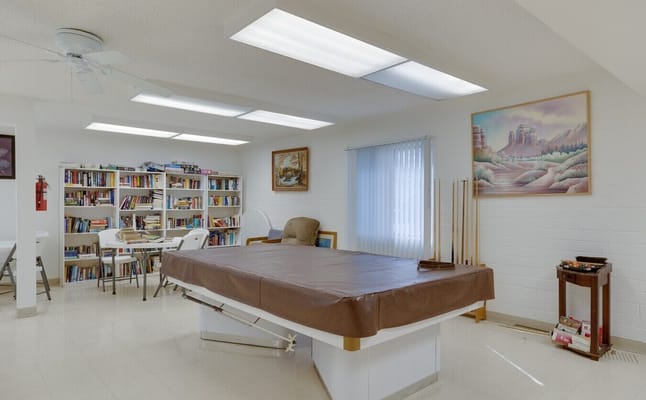 Common area featuring a massage table and bookshelves