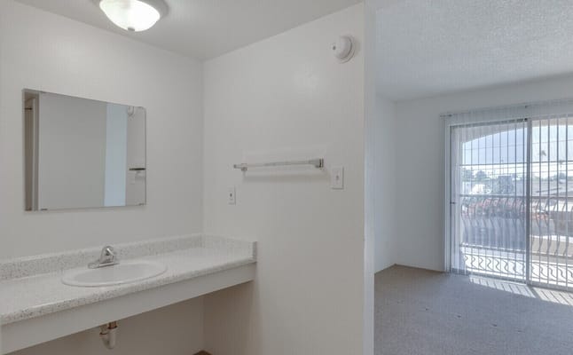 Clean bathroom with a sink and mirror at Hacienda De Los Arcos
