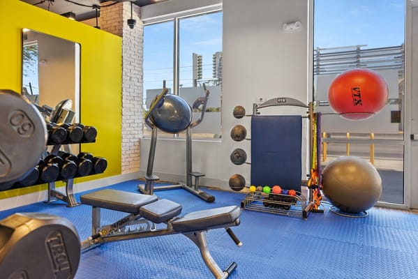 Well-equipped gym with weights and exercise equipment