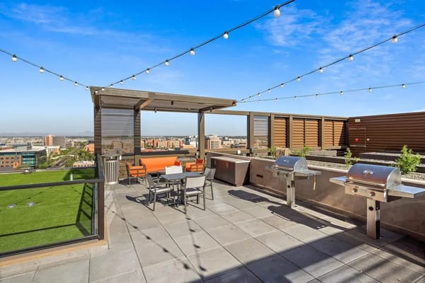 Rooftop patio with seating and grills