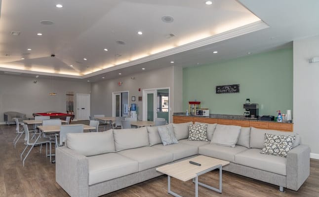 Comfortable lounge area with seating and coffee bar.