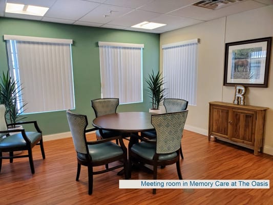 Meeting room with a round table and chairs at The Oasis