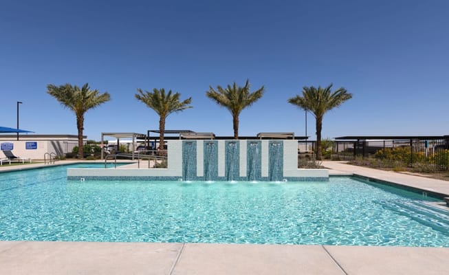 Swimming pool with waterfall and palm trees
