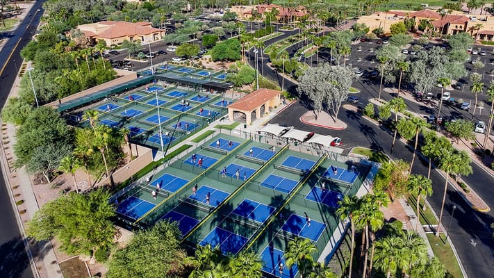 Aerial view of outdoor tennis courts with players