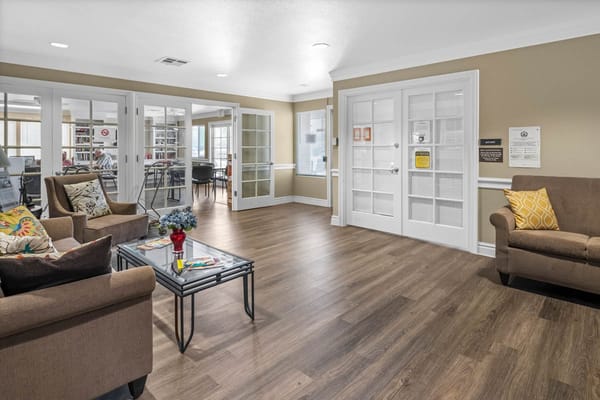 Cozy lounge area with seating and a view of the library.