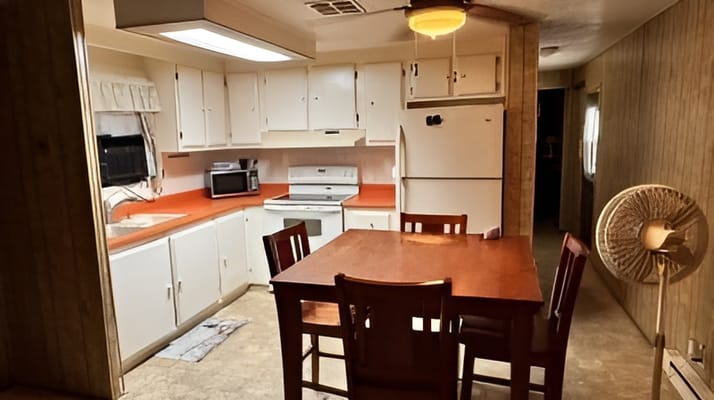 Cozy kitchen with dining table and appliances