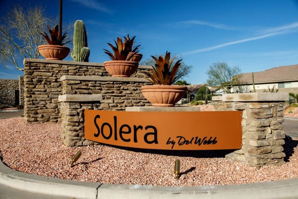 Sign for Solera at Johnson Ranch with decorative plants