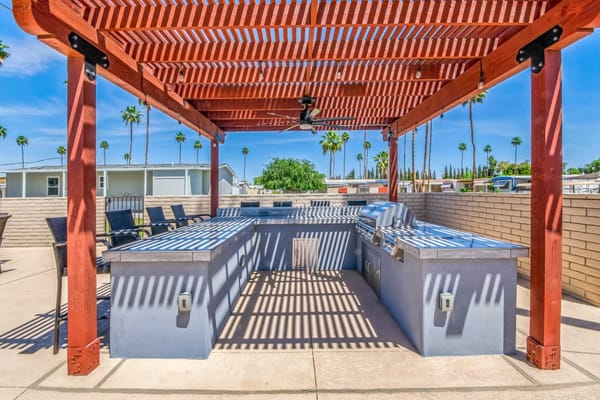 Outdoor barbecue area with shaded seating