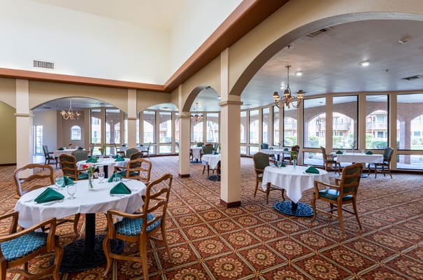 Elegant dining area with tables and chairs in Emerald Springs Senior Living.