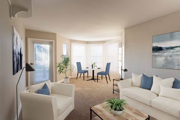 Spacious living room with a sofa, chairs, and dining area.