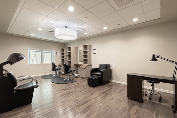 A well-lit salon area with chairs and workstations