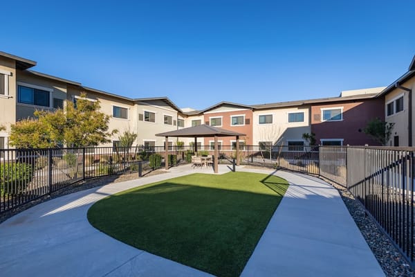 Well-maintained outdoor garden with seating area and gazebo