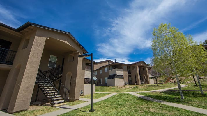 View of apartments with walkways and greenery at Village At Lake Mary Crossing.