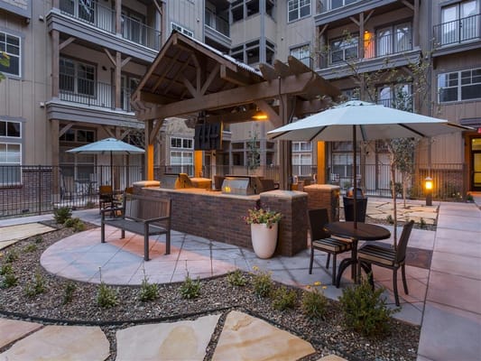 Outdoor patio area with seating and umbrellas