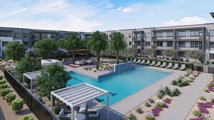 View of the swimming pool surrounded by palm trees and seating areas.