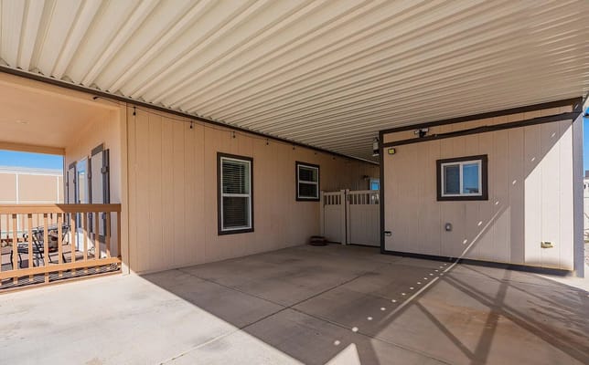 Covered patio area with floor and walls.