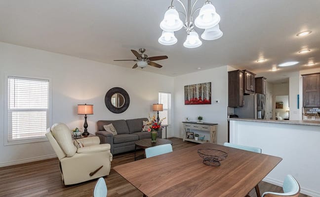 A spacious living and dining area featuring a comfortable couch, dining table, and modern decor.