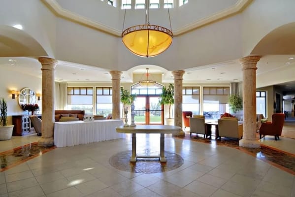 Luxurious lobby with a chandelier and seating area