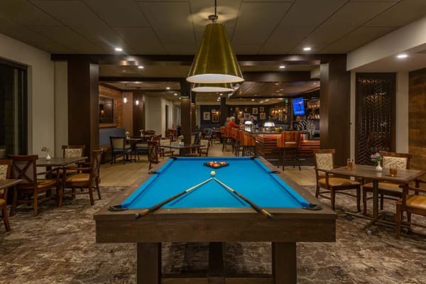 Indoor common area featuring a billiard table and seating