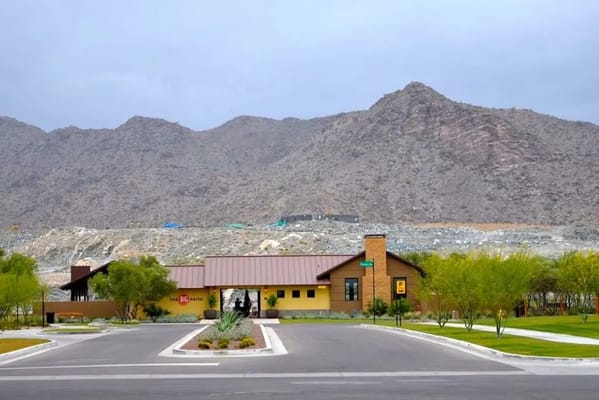 Exterior view of a senior living facility with mountains in the background