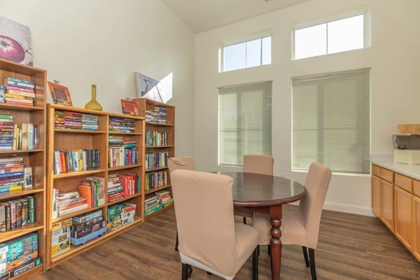 Interior common area with bookshelves and dining table