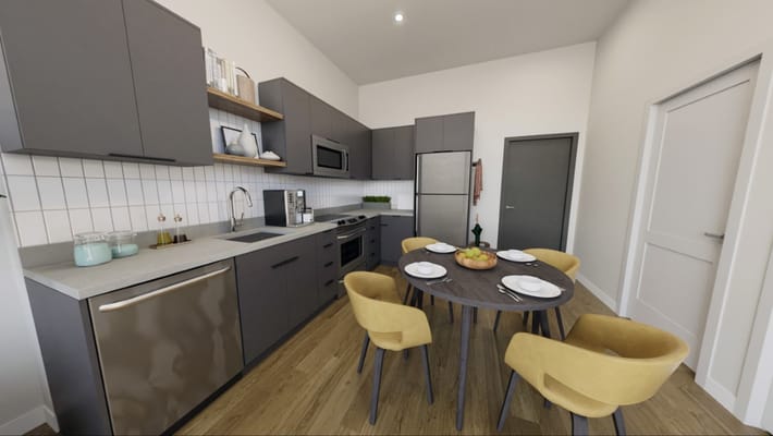 Modern kitchen with dining area in a senior living facility