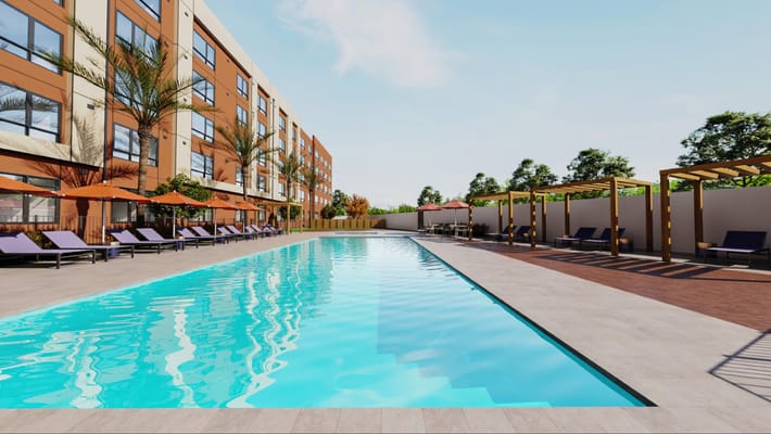 Outdoor pool area with lounge chairs and landscaping