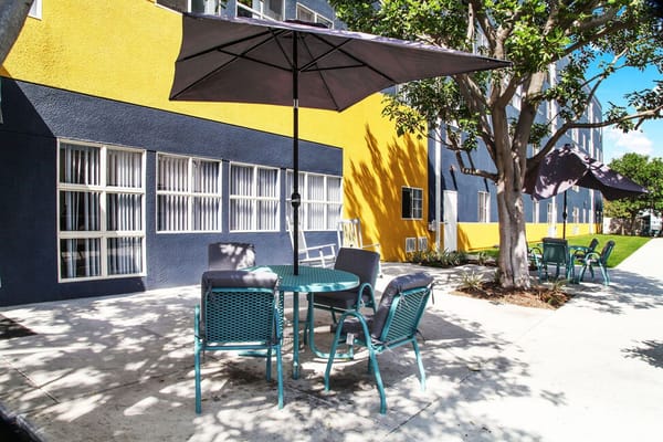 Outdoor seating area with umbrellas and colorful walls
