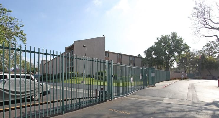 Exterior view of the gated entrance of Del Amo Gardens