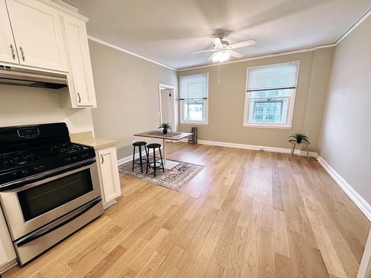 Modern kitchen and living room with hardwood floors