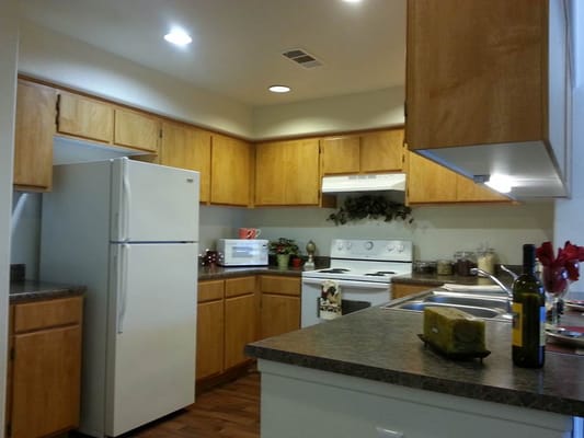 Bright kitchen with wooden cabinets and appliances