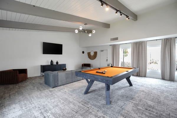Bright common area with a pool table and modern decor