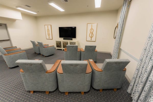 Common area with recliners and a television