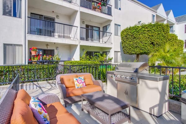 Outdoor patio area with seating and grill