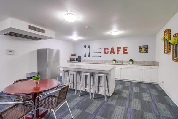 Bright cafe area with seating and appliances