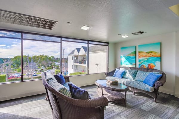 Bright common area with seating and large windows