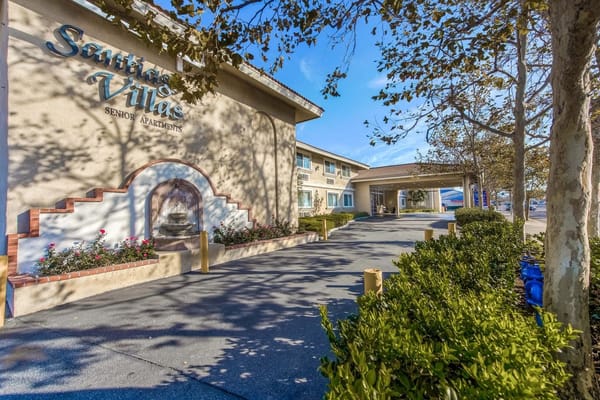 Front view of Santiago Villas Senior Apartments with landscaped entrance.