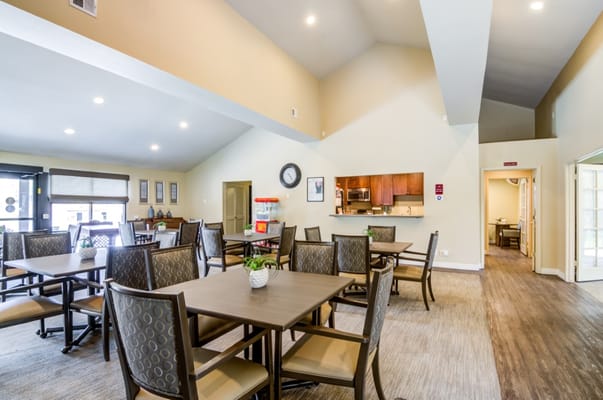Spacious common area with dining tables and kitchenette