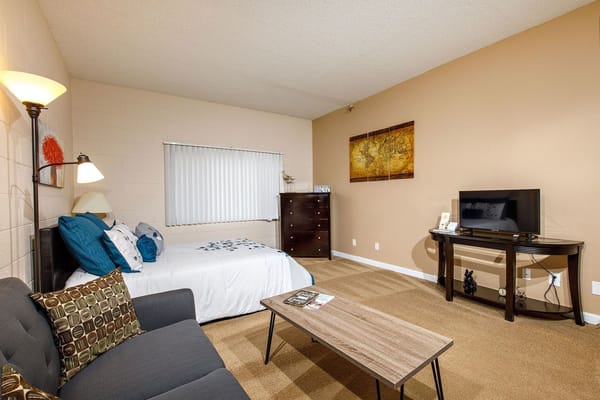 A well-furnished private resident room with seating