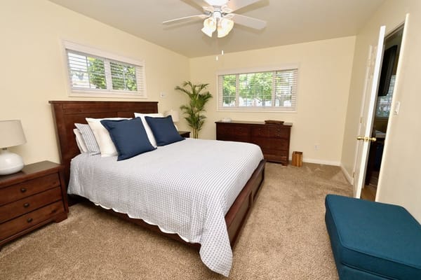 A well-furnished resident bedroom with natural light