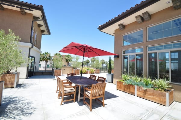 Outdoor seating area with a table and umbrella