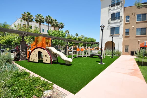 Outdoor playground area with slides and seating