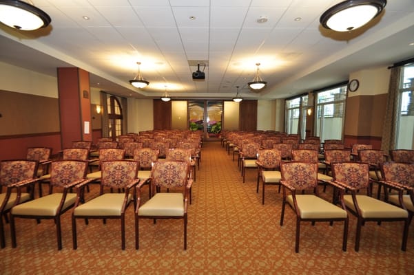 Interior meeting room with rows of empty chairs