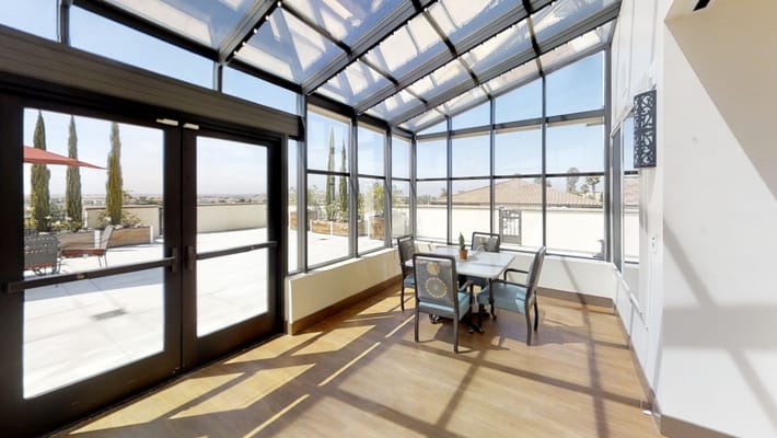 Indoor sunroom with dining table and views