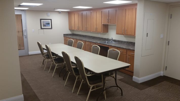 Bright common area with a long table and chairs