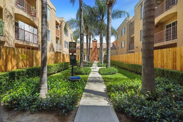 Pathway through a landscaped garden between apartment buildings